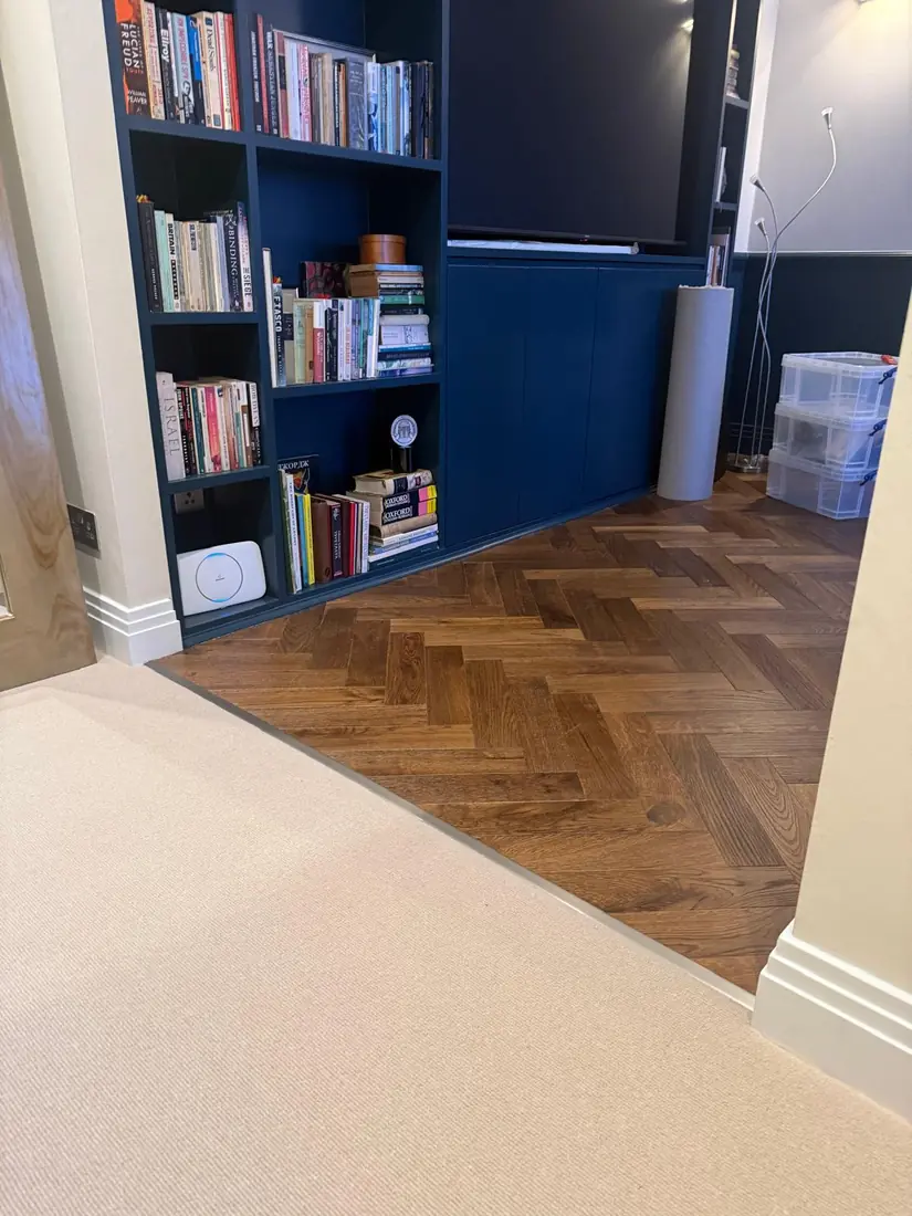 New carpet meeting a parquet floor in a flat