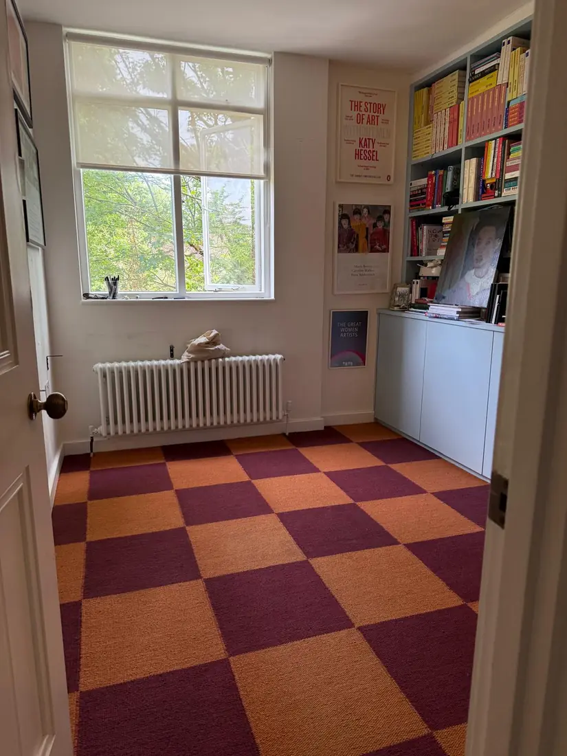 Red and orange checkerboard carpet tiles in a study