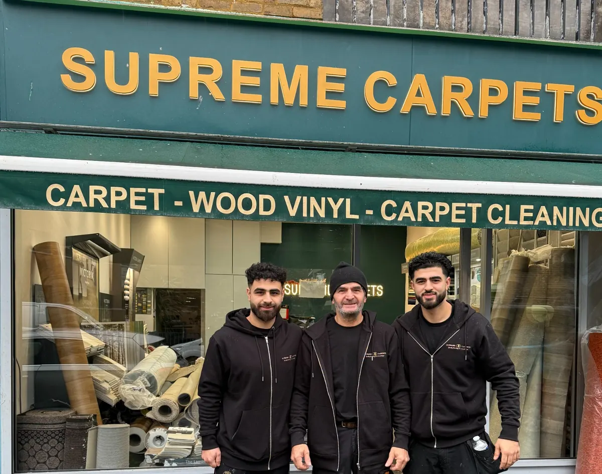 Jamal and his two sons outside the Supreme Carpets showroom on Bourne Terrace, W2