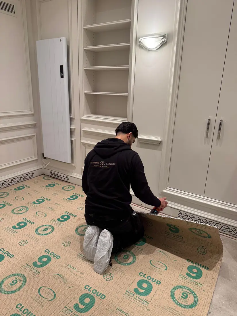 Supreme Carpets fitter laying underlay