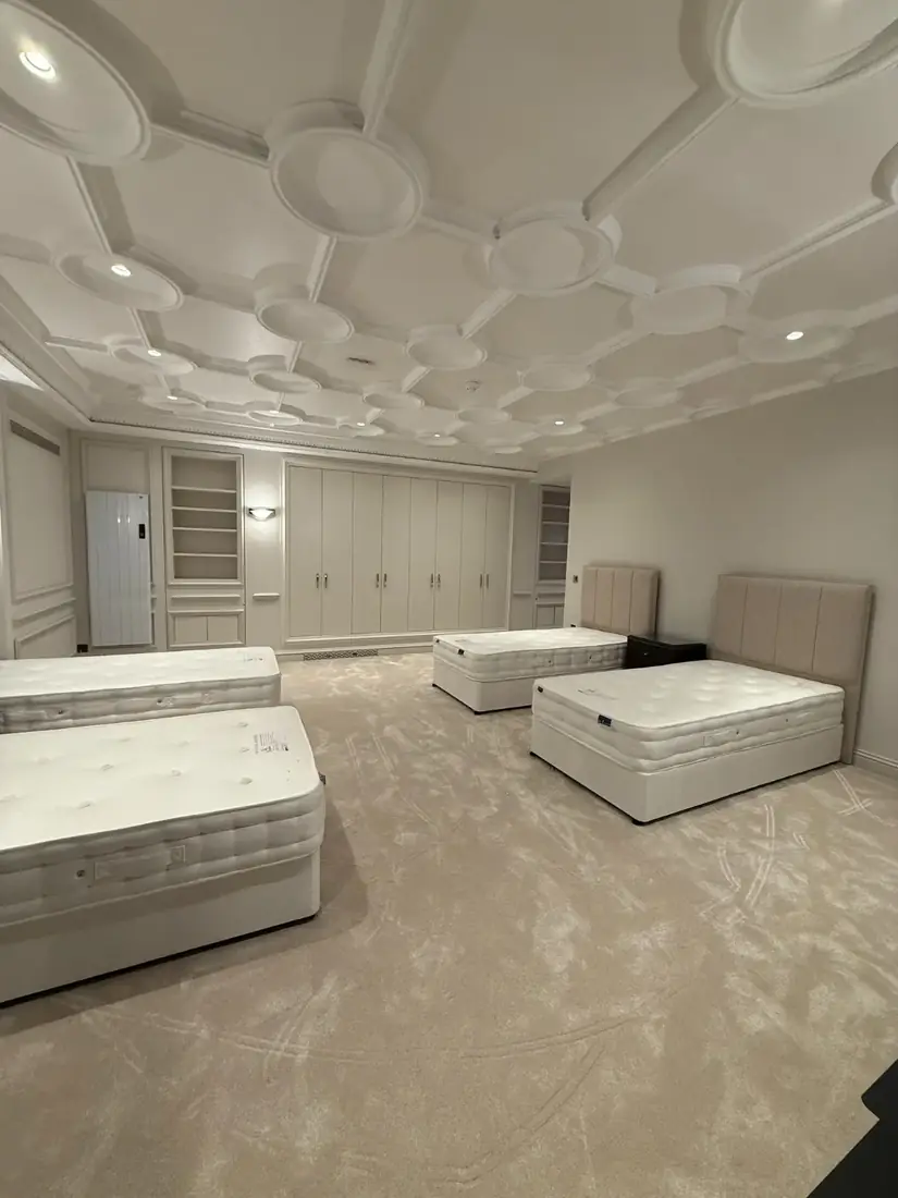Pale carpet in a large bedroom