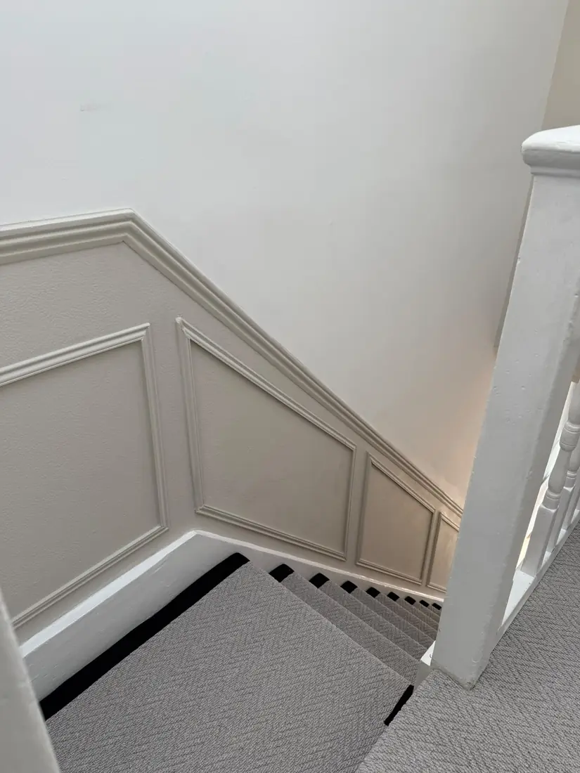 Grey carpet on a landing and stairs with black edging