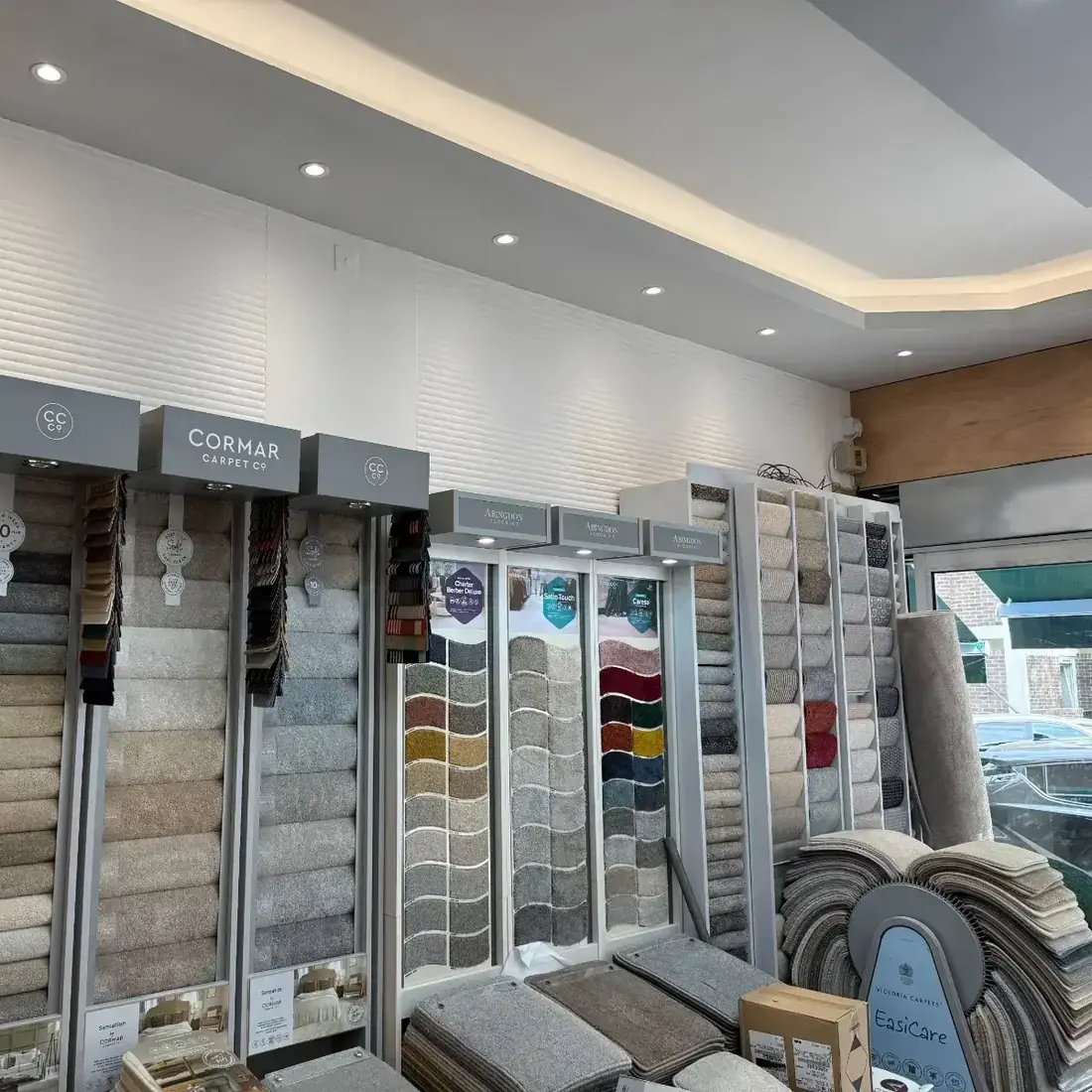 Wall of carpet sample boards from Cormar and other brands in the Supreme Carpets showroom