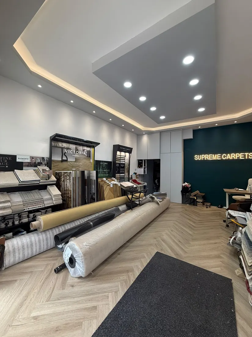 Inside the Supreme Carpets showroom at 94 Bourne Terrace, W2, with carpet rolls and sample displays