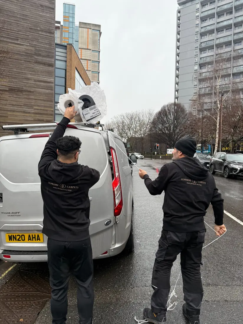 Two fitters loading the van